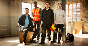 Group of four trade professionals wearing durable workwear, including hi-vis, hoodies, and jackets, standing in an industrial site with tools and safety gear. Pro RTX workwear.