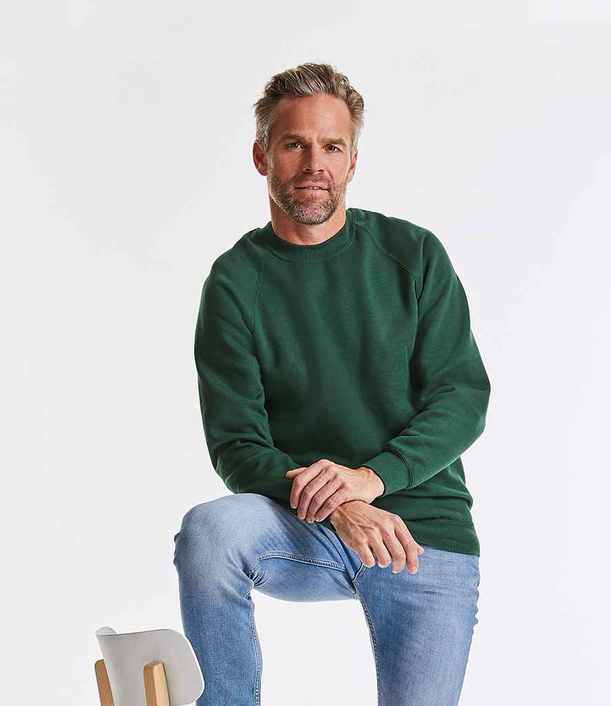 Russell Raglan Sweatshirt in Bottle Green by Russell — Custom branded clothing by Print Press, featuring premium embroidery produced in our specialist print lab in the UK.