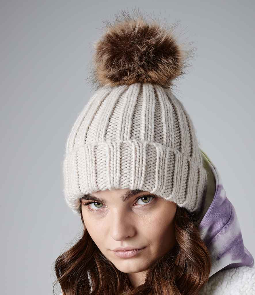 Beechfield Faux Fur Pop Pom Chunky Beanie in ONE Oatmeal by Beechfield — Custom branded clothing by Print Press, featuring premium embroidery produced in our specialist print lab in the UK.