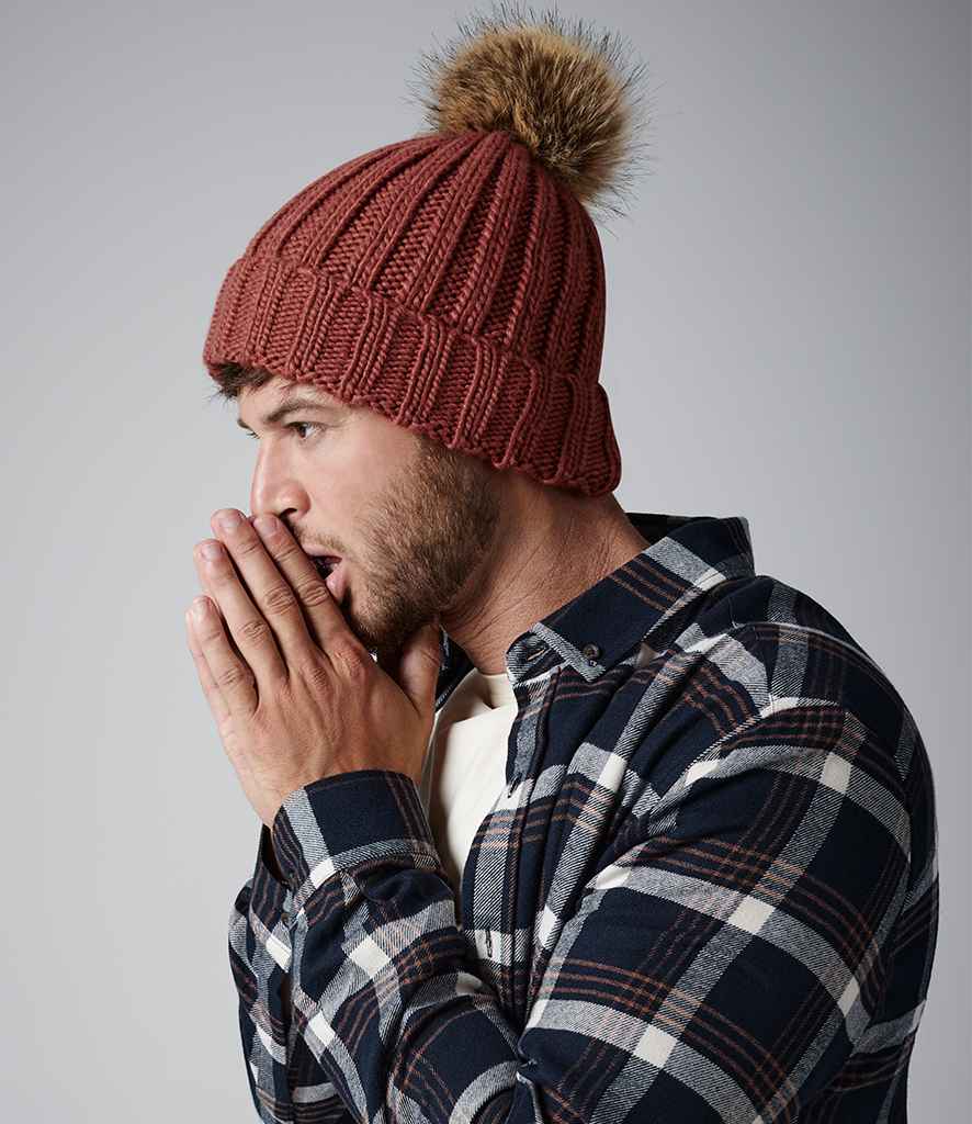 Beechfield Faux Fur Pop Pom Chunky Beanie in ONE Orange Rust by Beechfield — Custom branded clothing by Print Press, featuring premium embroidery produced in our specialist print lab in the UK.