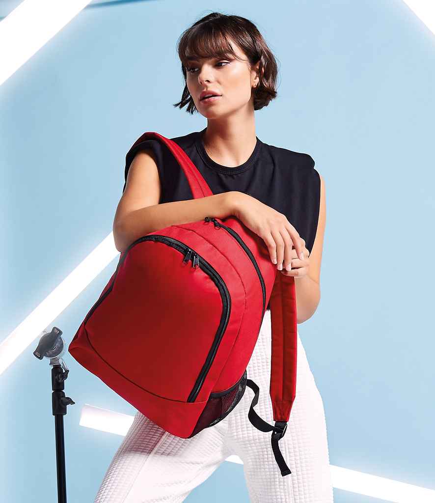 BagBase Universal Backpack in ONE Classic Red by Bagbase — Custom branded clothing by Print Press, featuring premium embroidery produced in our specialist print lab in the UK.