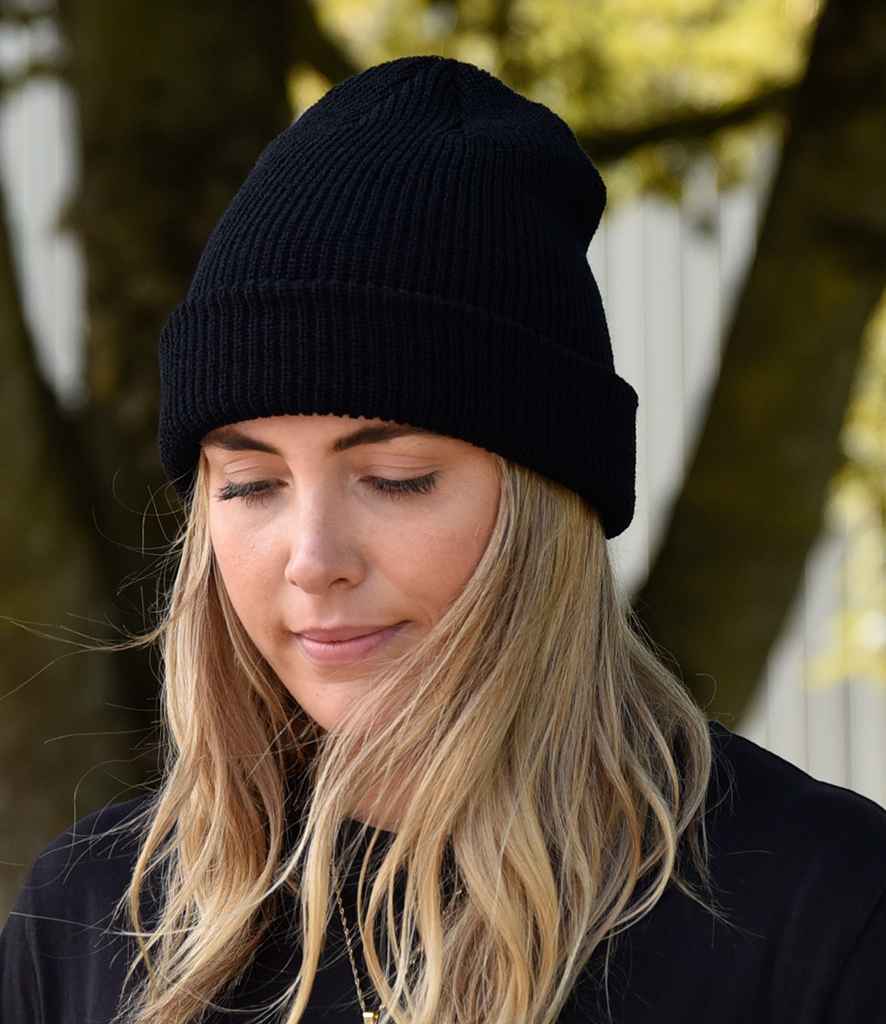 Flexfit Long Knit Beanie in ONE Black by Flexfit — Custom branded clothing by Print Press, featuring premium embroidery produced in our specialist print lab in the UK.