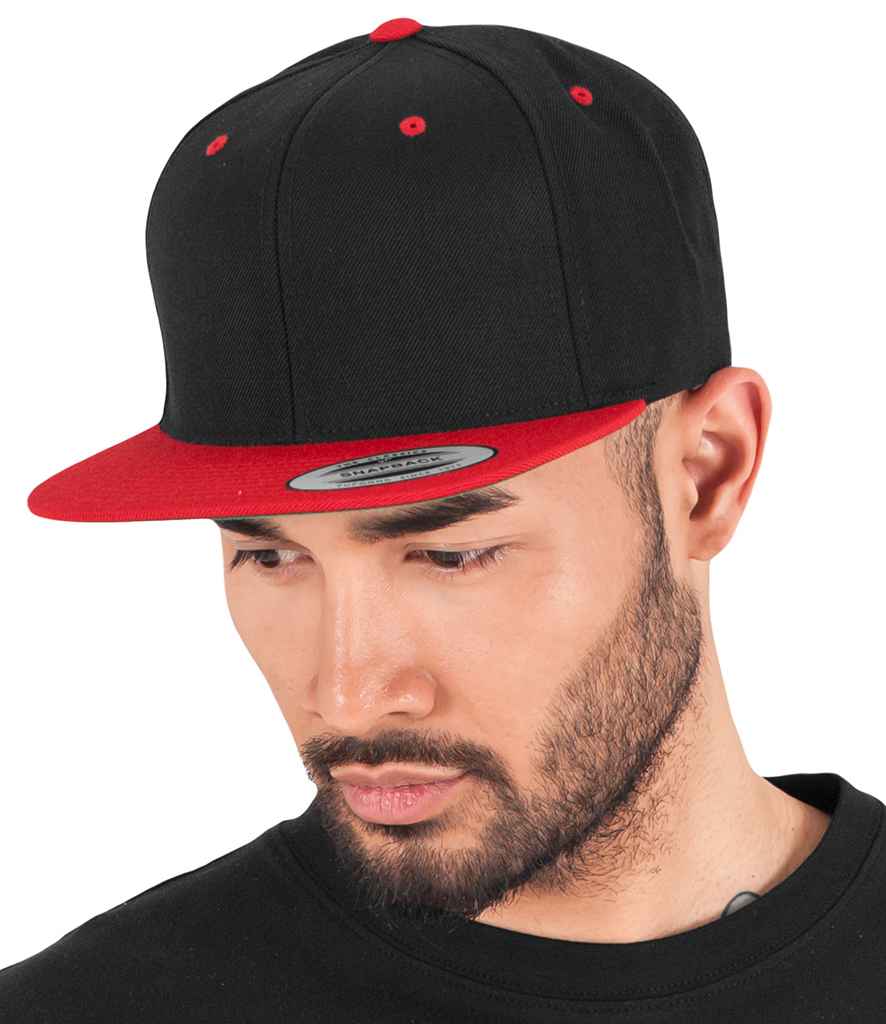 Flexfit Two Tone Classic Snapback Cap in ONE Black Red by Flexfit — Custom branded clothing by Print Press, featuring premium embroidery produced in our specialist print lab in the UK.