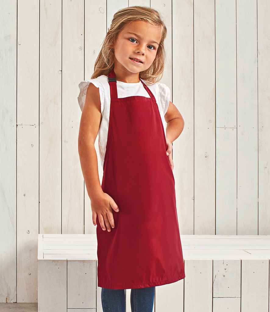 Premier Kids Waterproof Apron in Red by Premier — Custom branded clothing by Print Press, featuring premium embroidery produced in our specialist print lab in the UK.