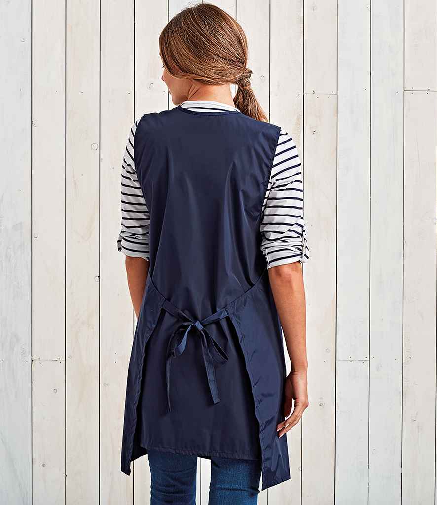 Premier Waterproof Wrap Around Tunic Apron in by Premier — Custom branded clothing by Print Press, featuring premium embroidery produced in our specialist print lab in the UK.