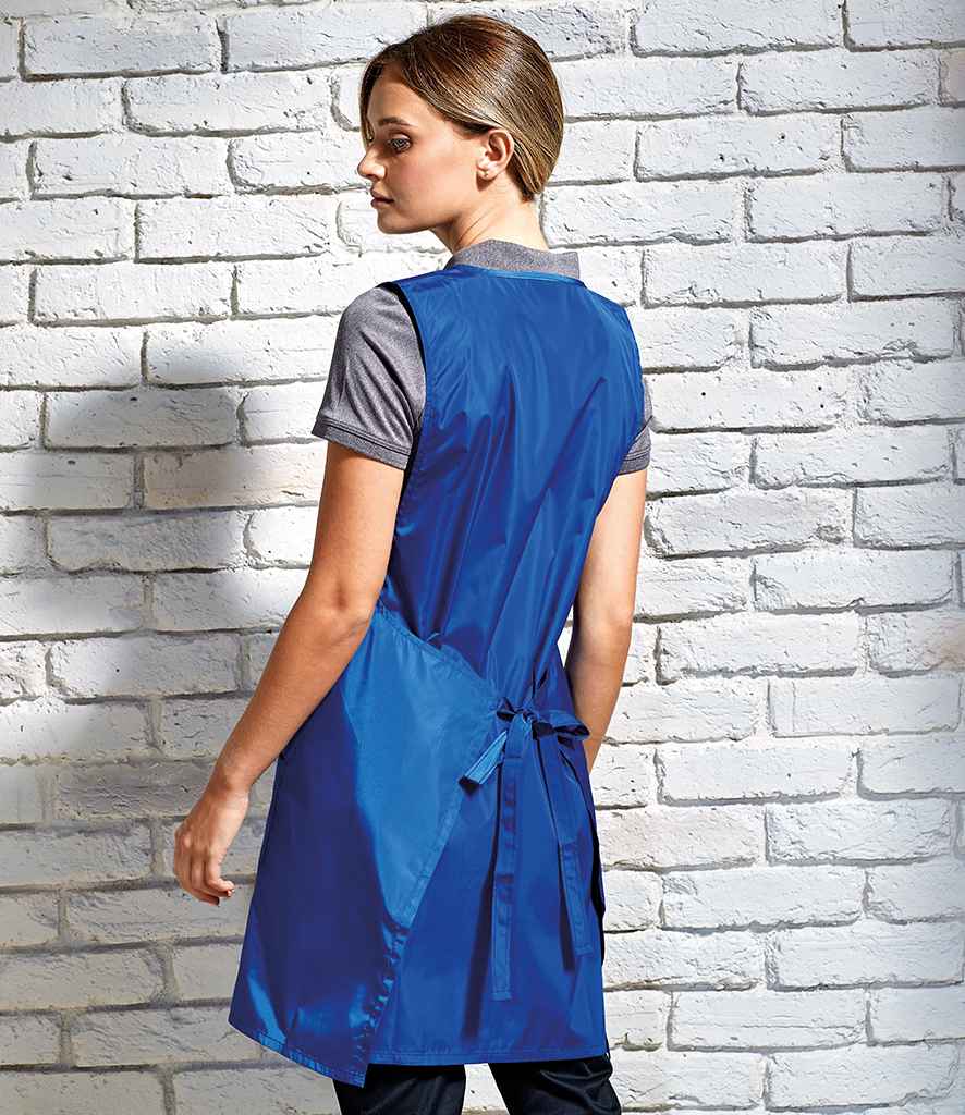 Premier Waterproof Wrap Around Tunic Apron in by Premier — Custom branded clothing by Print Press, featuring premium embroidery produced in our specialist print lab in the UK.