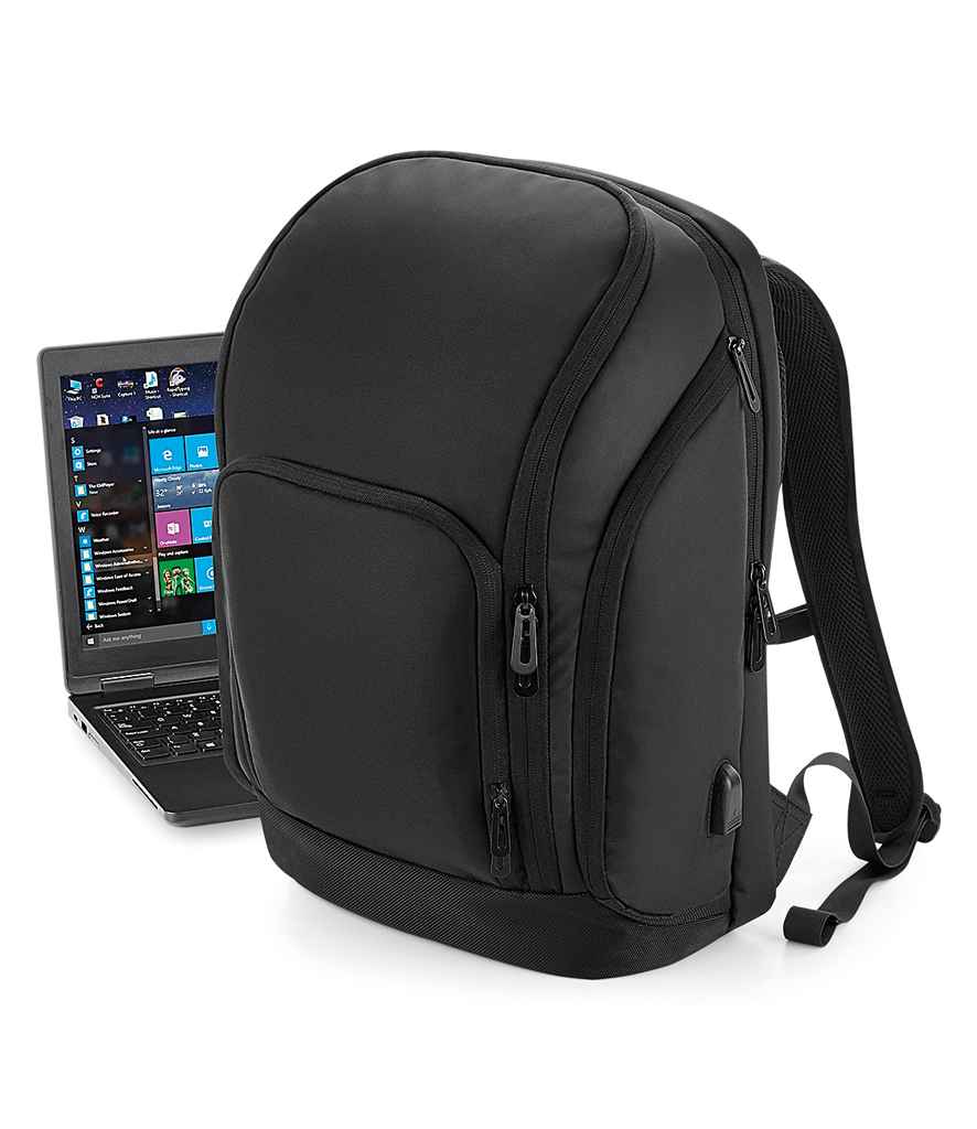 Quadra Pro-Tech Charge Backpack in ONE Black by Quadra — Custom branded clothing by Print Press, featuring premium embroidery produced in our specialist print lab in the UK.