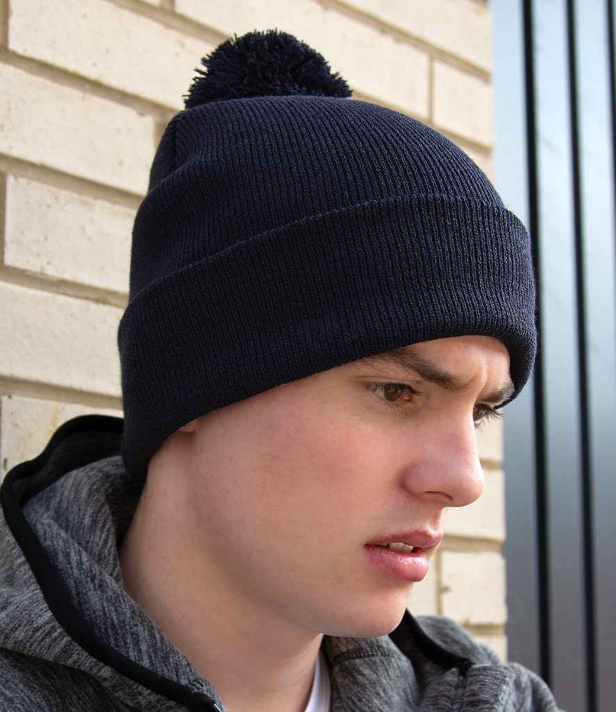 Result Core Pom Pom Beanie in ONE Black by Result Winter Essentials — Custom branded clothing by Print Press, featuring premium embroidery produced in our specialist print lab in the UK.