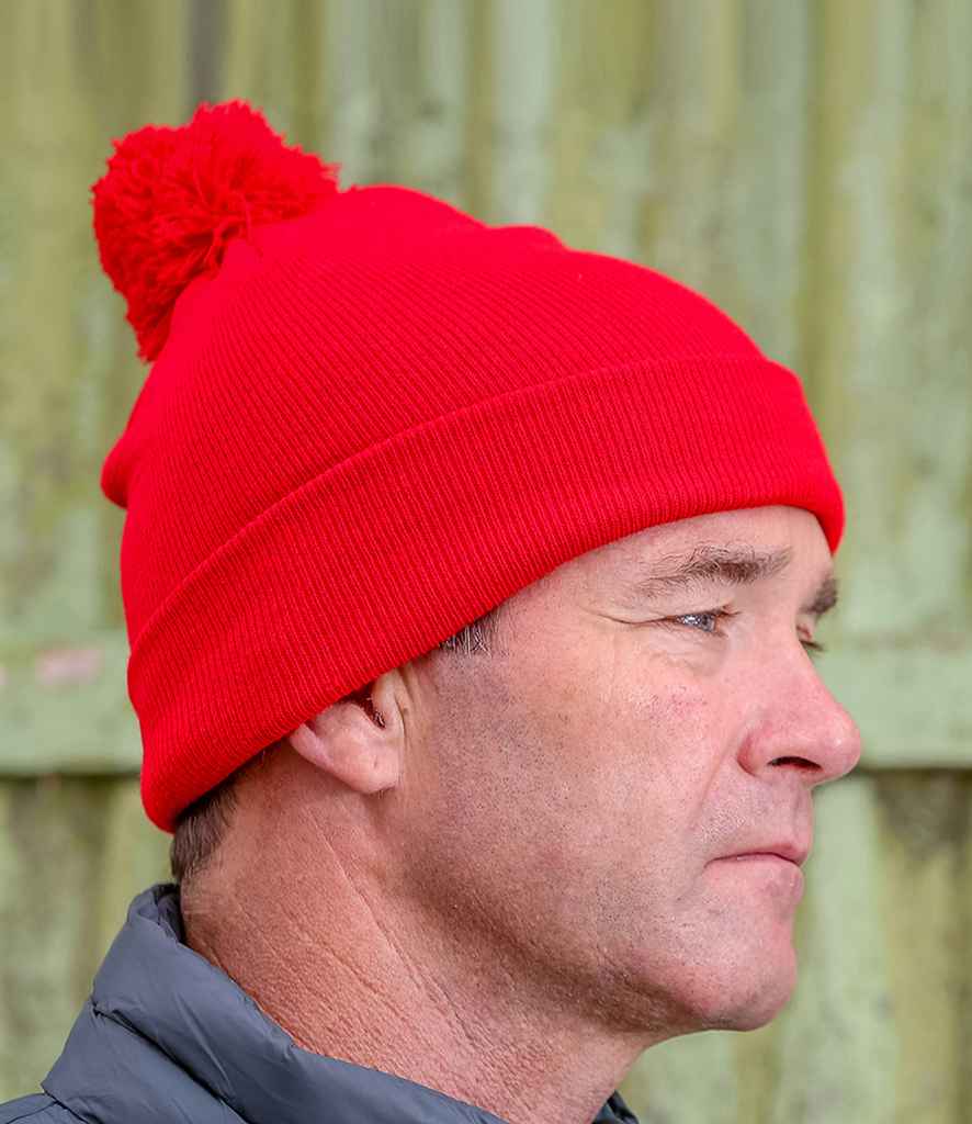 Result Core Pom Pom Beanie in ONE Red by Result Winter Essentials — Custom branded clothing by Print Press, featuring premium embroidery produced in our specialist print lab in the UK.