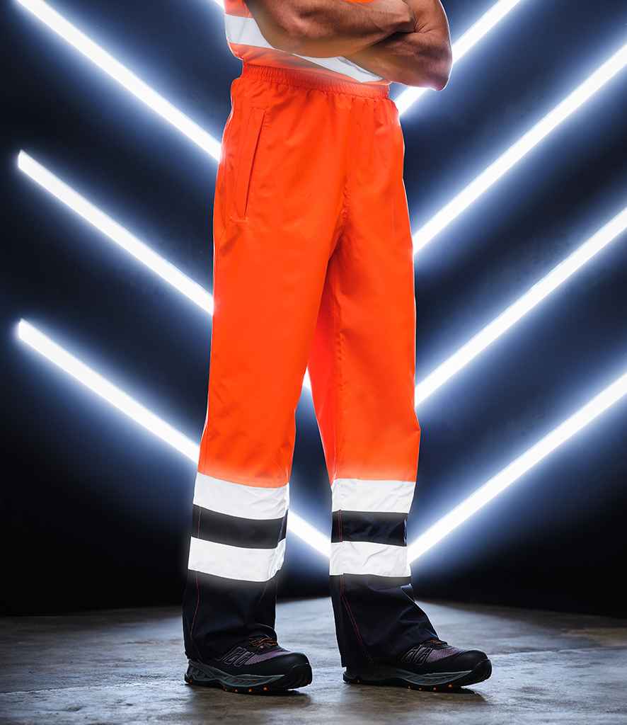 Regatta High Visibility Pro Contrast Overtrousers in Orange Navy by Regatta High Visibility — Custom branded clothing by Print Press, featuring premium embroidery produced in our specialist print lab in the UK.