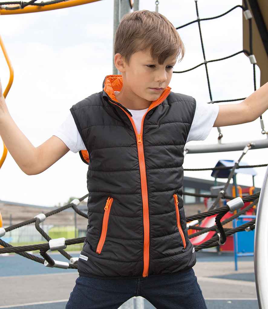 Result Core Kids Padded Bodywarmer in Black Orange by Result Core — Custom branded clothing by Print Press, featuring premium embroidery produced in our specialist print lab in the UK.