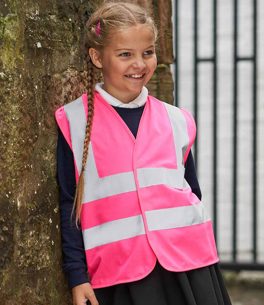 Pro RTX High Visibility Kids Waistcoat in Pink by Pro RTX High Visibility — Custom branded clothing by Print Press, featuring premium embroidery produced in our specialist print lab in the UK.