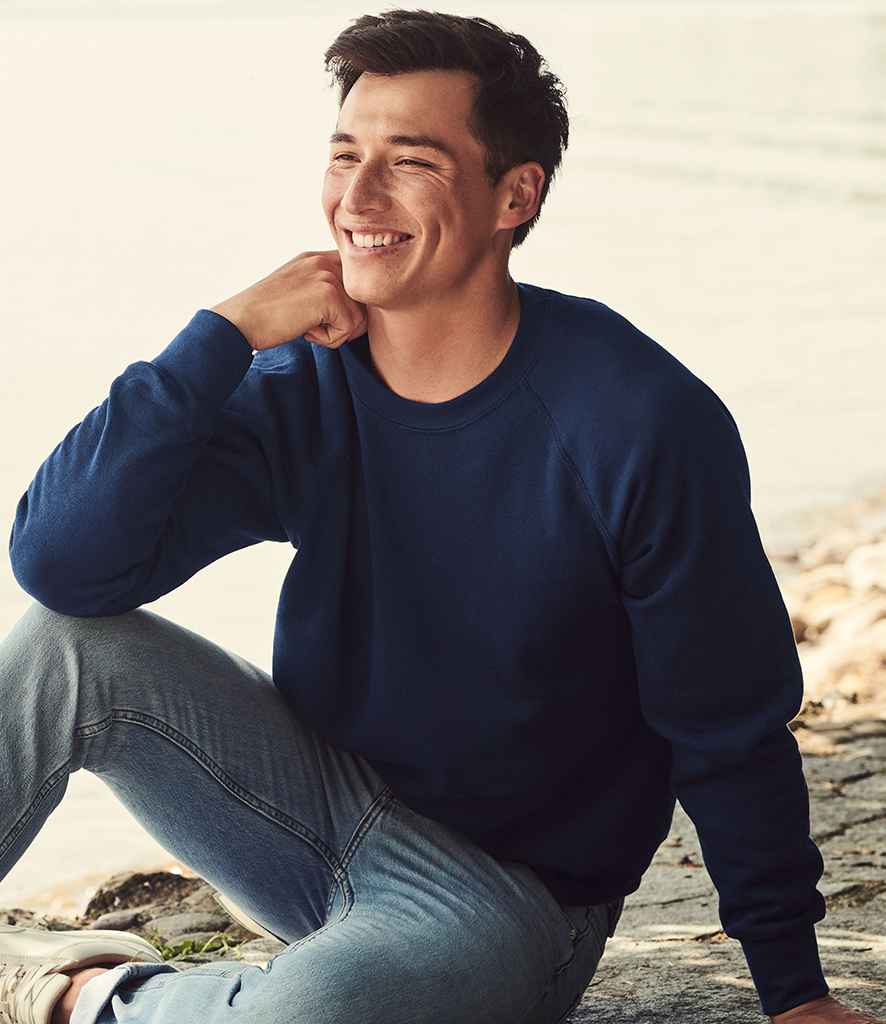 Fruit of the Loom Classic Raglan Sweatshirt in Navy by Fruit of the Loom — Custom branded clothing by Print Press, featuring premium embroidery produced in our specialist print lab in the UK.