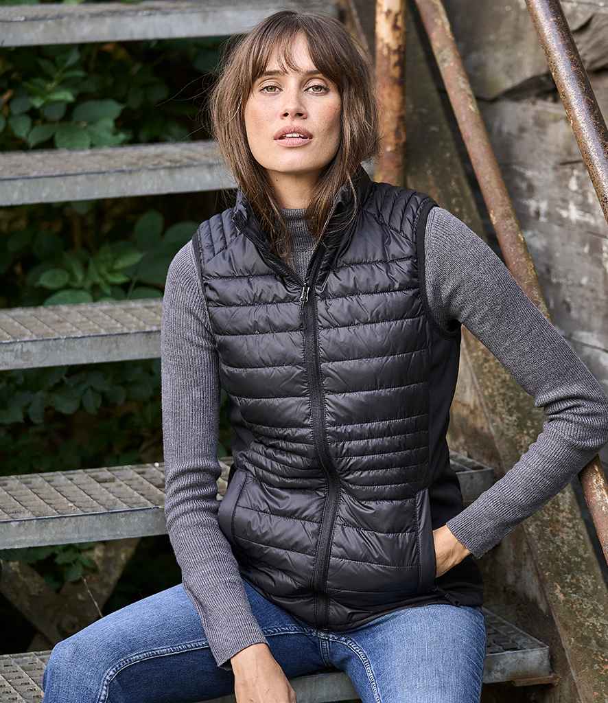 Tee Jays Ladies Crossover Padded Bodywarmer in Black Black by Tee Jays — Custom branded clothing by Print Press, featuring premium embroidery produced in our specialist print lab in the UK.