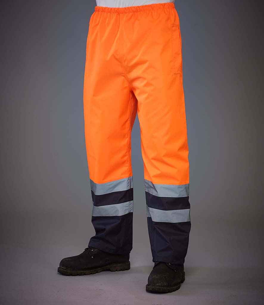 Yoko Hi-Vis Two Tone Waterproof Overtrousers in Orange Navy by Yoko — Custom branded clothing by Print Press, featuring premium embroidery produced in our specialist print lab in the UK.